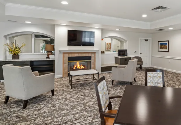 Senior Living in Lakewood featuring a beautiful lobby with a fireplace.