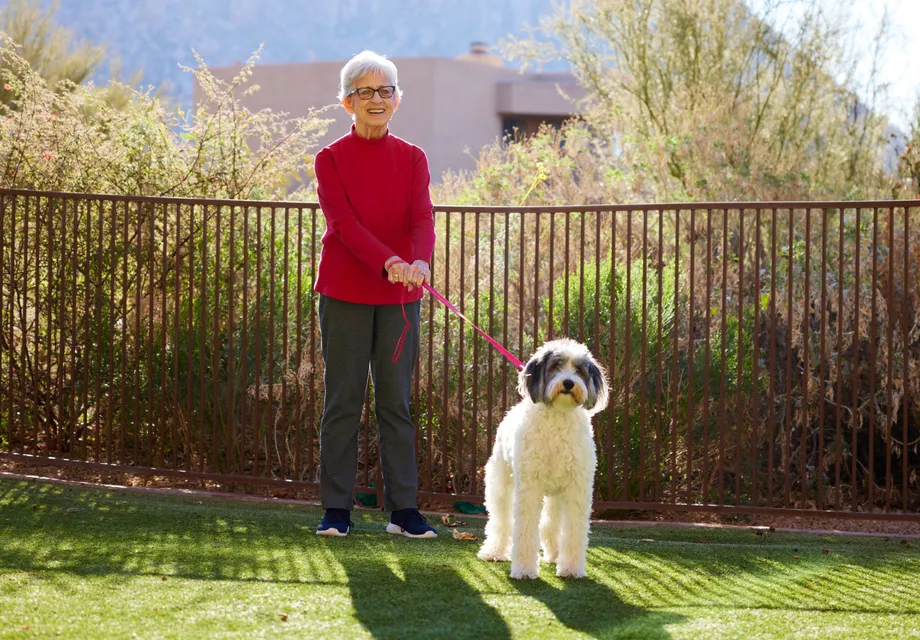Senior woman walking her dog.