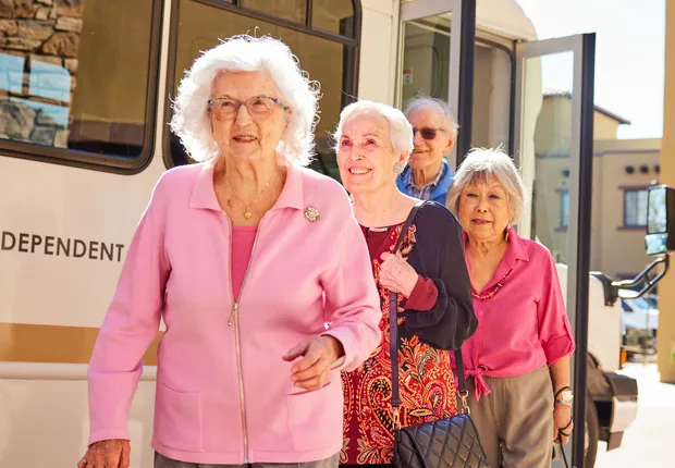 Group of senior women walking out of our bus.