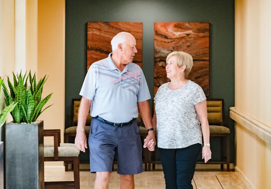 Senior couple walks through their senior living community