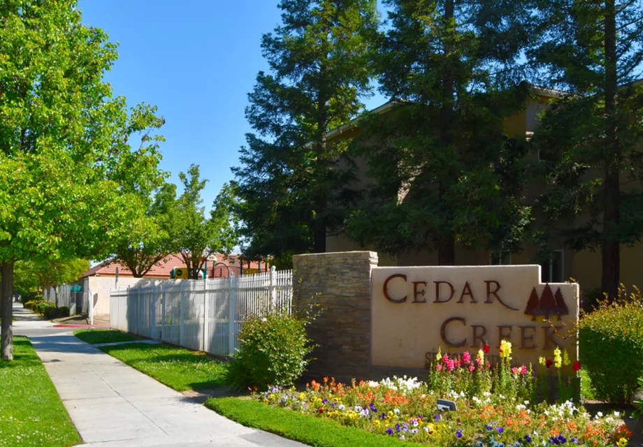 Senior Living in Madera sign surrounded by a small garden and walking paths