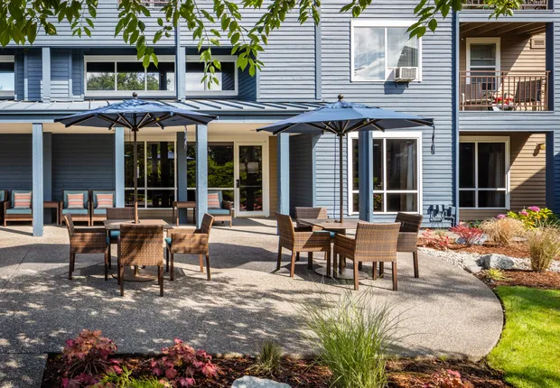 Patio with covered tables and plenty of seating in our Senior Living community in Tacoma