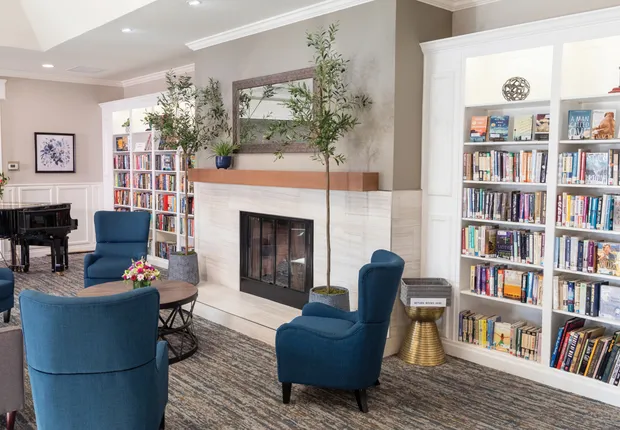 Fireplace and deep blue armchairs at out senior living community in Fremont