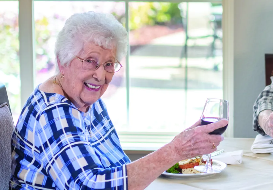 Senior apartments Madera CA offer bright living spaces to enjoy wine with friends.