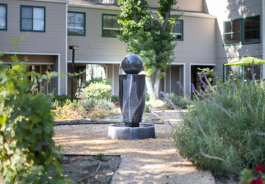 Senior Living in Vacaville featuring a modern statue in the green courtyard