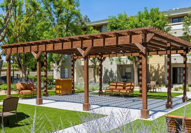 Senior Living in Fresno featuring a pergola in the middle of our courtyard.
