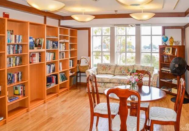 Our Senior living community in Belmont features a bright library with plenty of natural light.