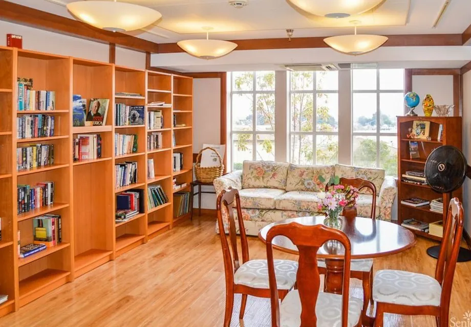 Our Senior living community in Belmont features a bright library with huge windows.