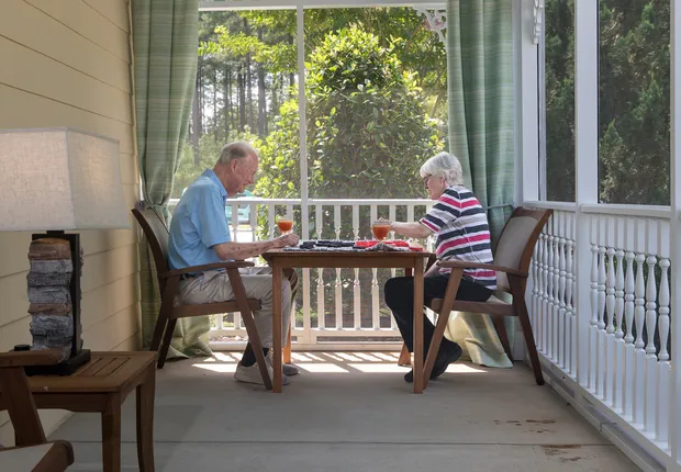 Two seniors dine outside at Cadence Garner by Cogir