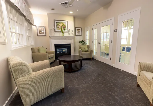 Senior living in Mooresville with cozy lobby, fireplace and natural light