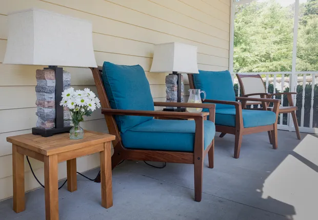 Cozy padded seats on the patio in Senior living in Mooresville
