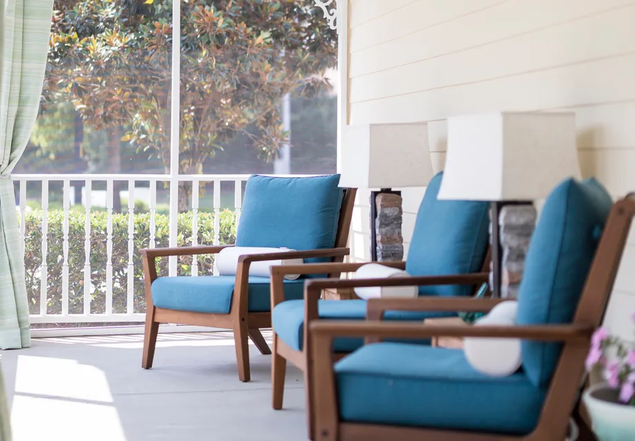 Senior Living in Raleigh featuring cozy padded chairs on their patio