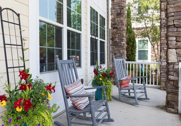 Senior Living in Wake Forest with rocking chairs outside.