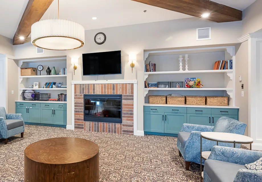 Senior living near Baltimore featuring a fireplace and mounted TV.