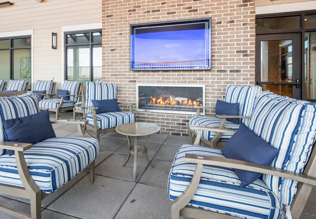 Outdoor patio with fireplace and TV in our Senior Living in Woodbridge, VA
