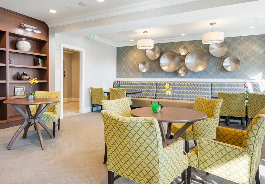 Cozy dining room with bright green chairs at Senior Living in Woodbridge, VA