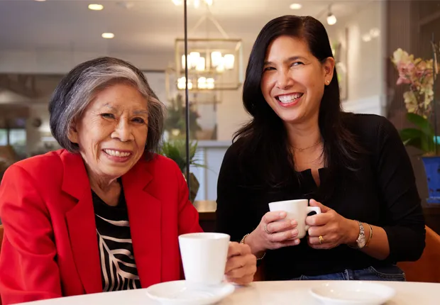 Senior woman and her daughter enjoying coffee together.