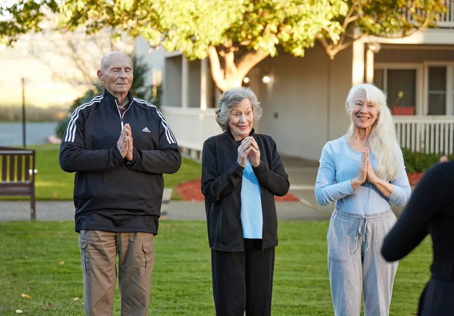 Senior program: fitness. Seniors gather for an outdoor yoga class.