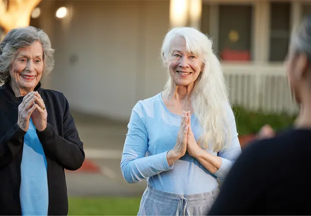 Senior woman smiling during a yoga class.