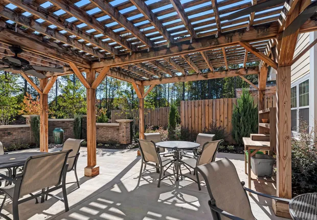 Senior Living in Clemmons: pergola with tables and chairs underneath.