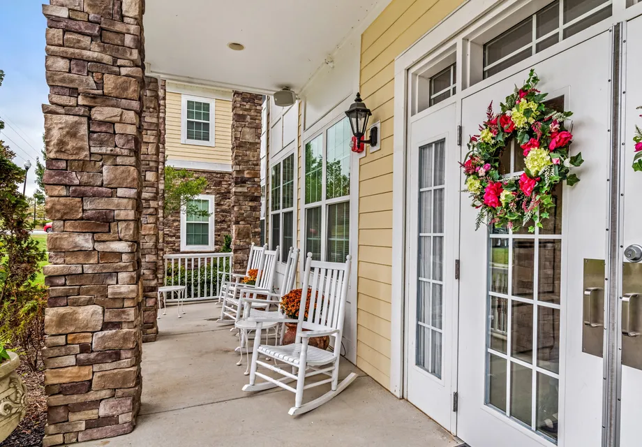Senior living featuring a large covered patio with rocking chairs