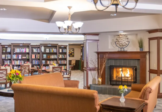 Senior living in Mill Creek featuring a fireplace and library