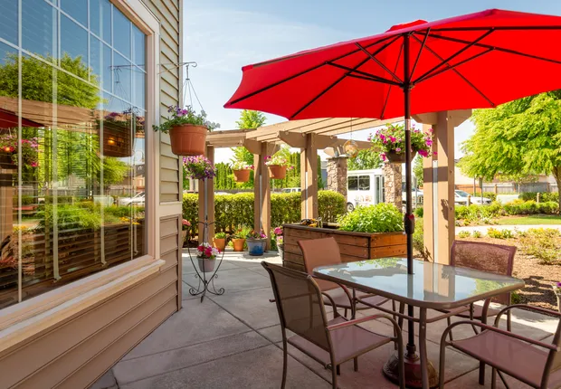 Senior Living in Vancouver, WA with shaded seating on a balcony.