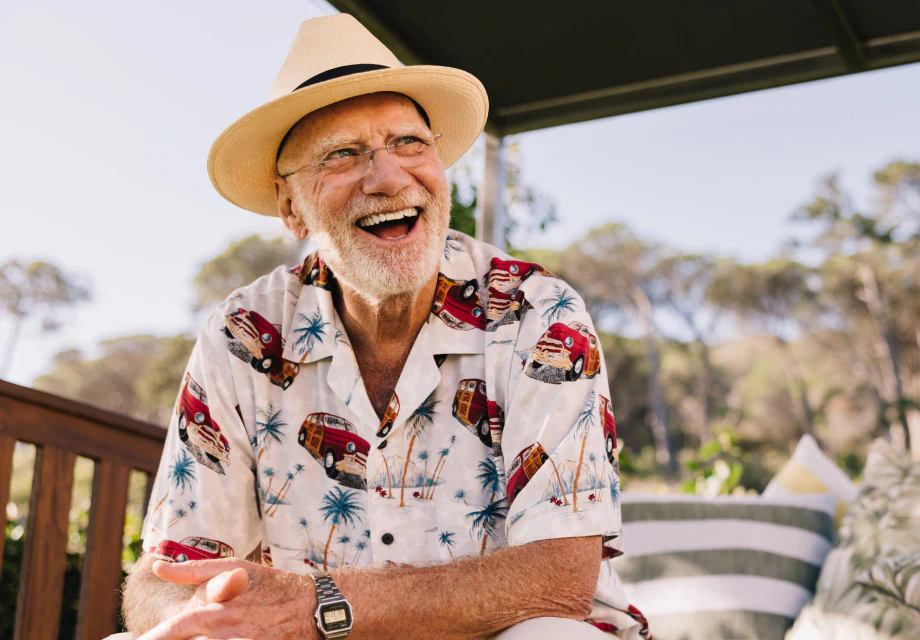 a happy senior man smiling outside