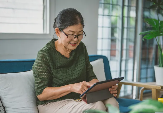 Senior woman looking at a tablet.