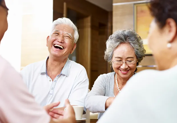 Senior couple laughing at happy hour.