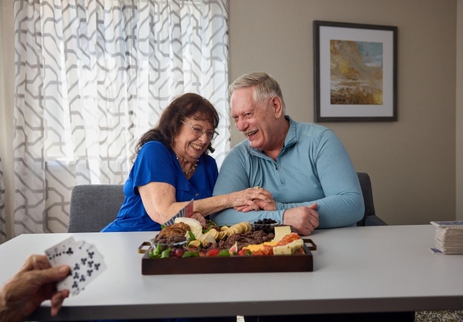 senior couple smiling over meal