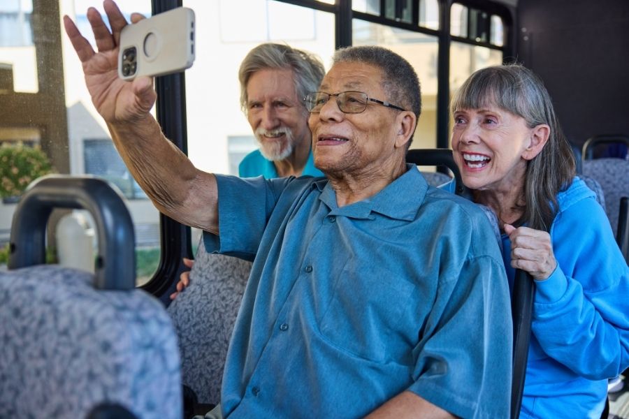 seniors taking a selfie on a bus