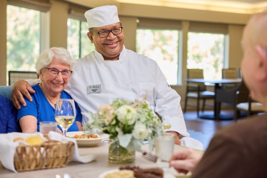 chef and senior smiling for picture