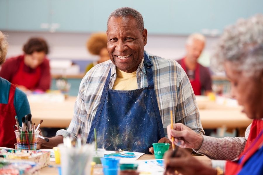 senior smiling during painting class