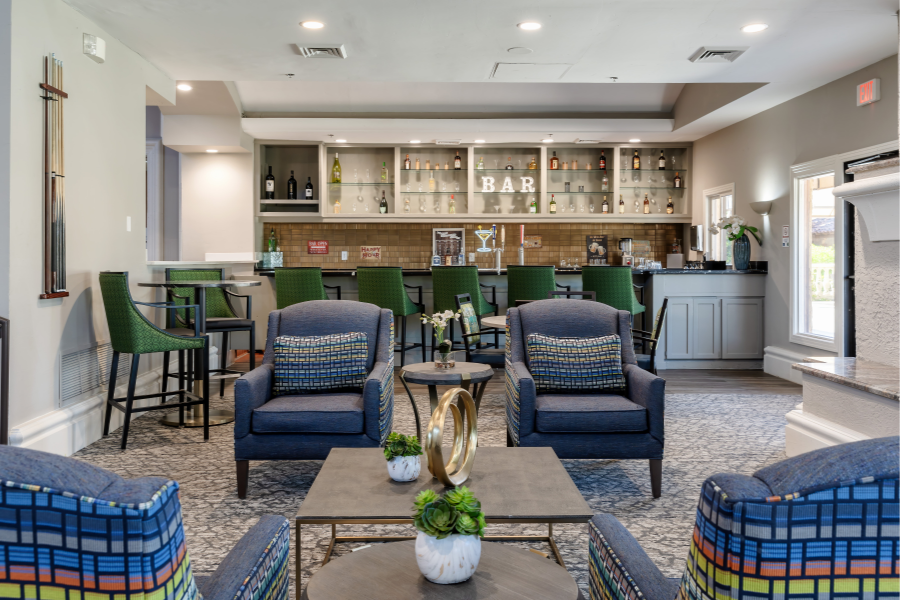 Comfortable bar area with plush chairs, elegant decor, and a well-stocked display at Park Terrace Senior Living in Phoenix, AZ.