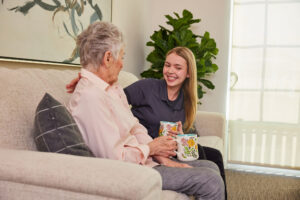 Cogir staff sitting with resident.