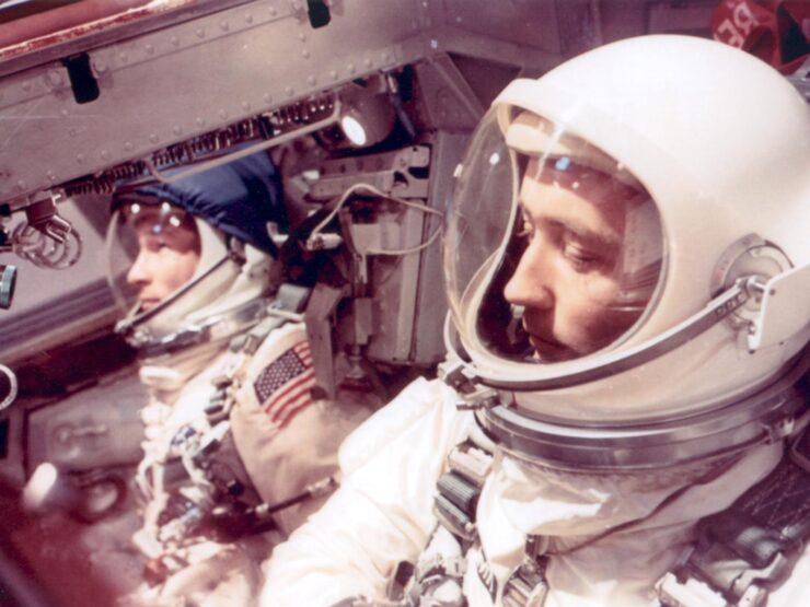 Two astronauts are focused and ready within a spacecraft, embodying teamwork and exploration.