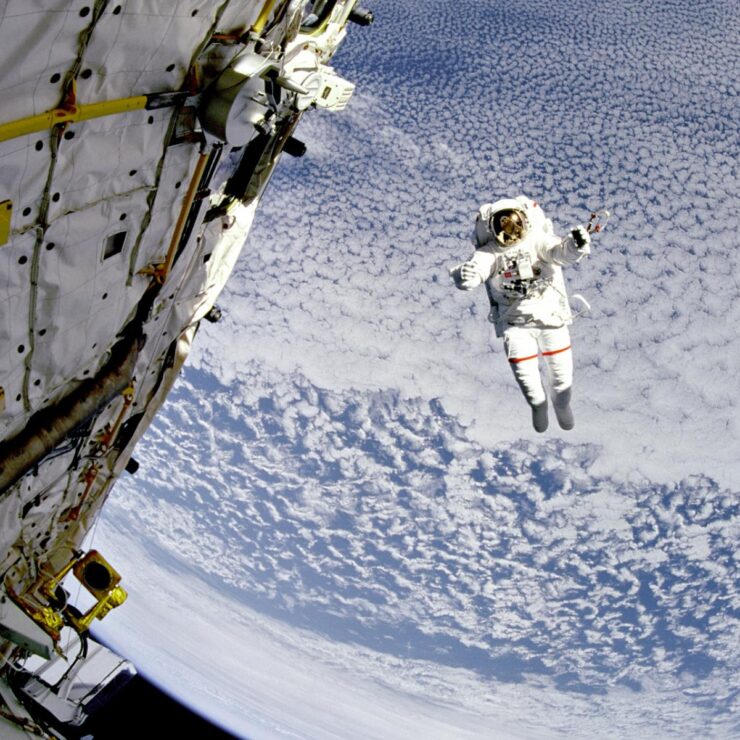 The scene captures a sense of wonder and exploration, highlighting the vastness of the sky with clouds below.