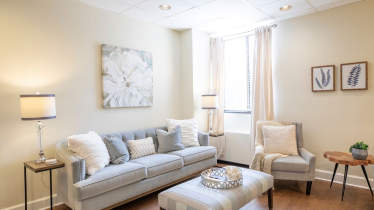 A serene lounge area filled with soft light, inviting seating, and tasteful decor, perfect for gatherings.