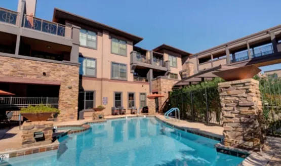 Bright and inviting, this serene outdoor oasis features a sparkling pool surrounded by comfortable seating, inviting community interactions.