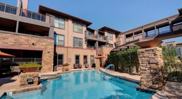 Bright and inviting, this serene outdoor oasis features a sparkling pool surrounded by comfortable seating, inviting community interactions.