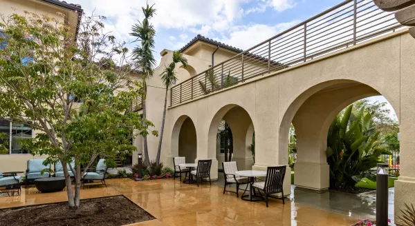 Bright outdoor spaces invite connection and relaxation among lush greenery and elegant architecture.