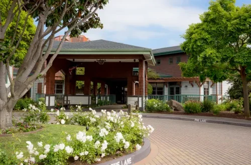 Nestled among vibrant gardens, the welcoming entrance invites residents to a warm community atmosphere.