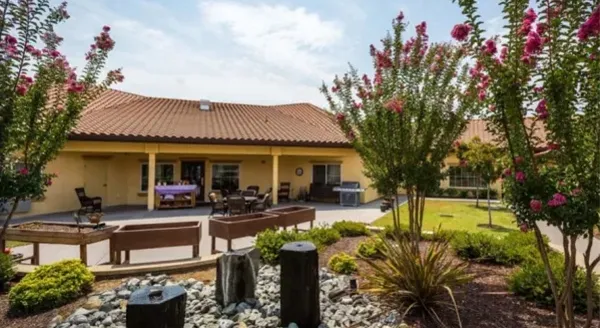 A serene garden setting with vibrant flowers, inviting seating, and a welcoming atmosphere for community gatherings.