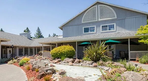 A welcoming residence surrounded by lush gardens, perfect for relaxation and community gatherings.