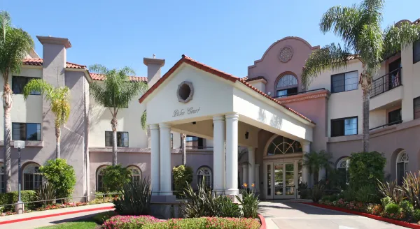 Inviting entrance surrounded by vibrant gardens, reflecting a warm, inclusive community atmosphere.