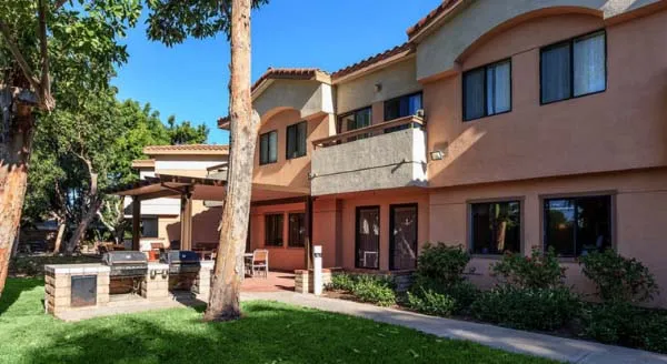 A welcoming outdoor space featuring well-maintained greenery and inviting seating, perfect for community gatherings.