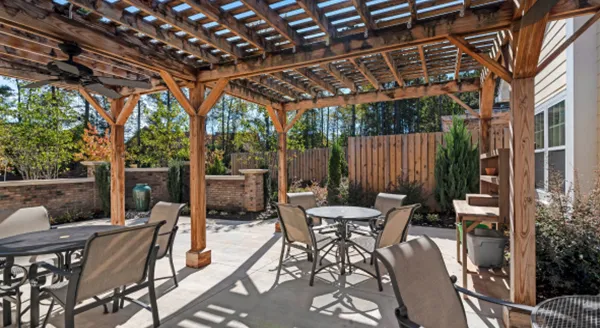 A welcoming outdoor area with shaded seating invites relaxation and community gatherings in nature.