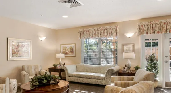 A bright and inviting lounge featuring comfortable seating, cheerful decor, and warm natural light.