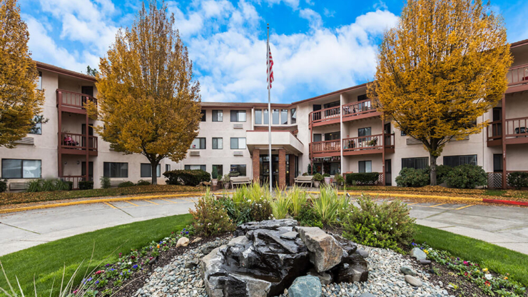 A welcoming community hub surrounded by vibrant trees and serene landscaping, radiating comfort.
